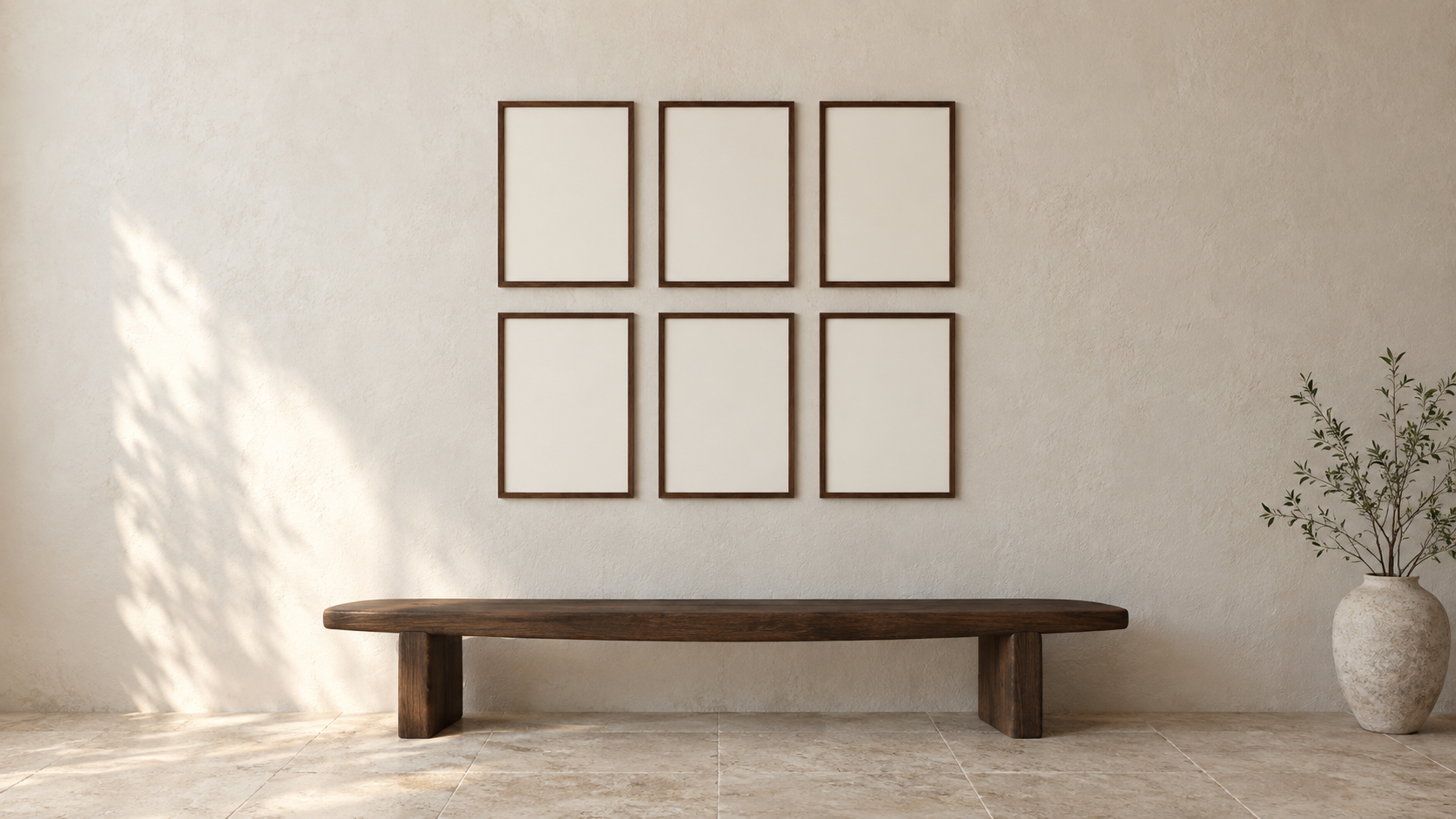 A warm gallery wall with six walnut frames above a wooden bench
